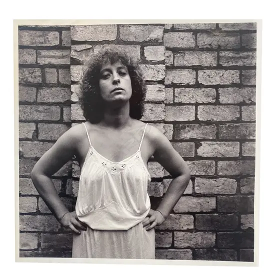 Unidentified photographer ‘Portrait of woman standing in front of brick wall’,